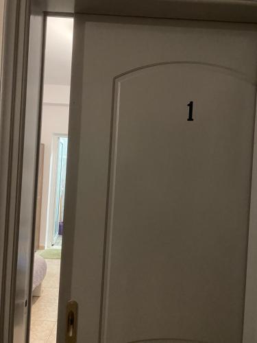 a white door with the number one on it at Sunset Villa Apartments Alepokhori in Káto Alepokhórion