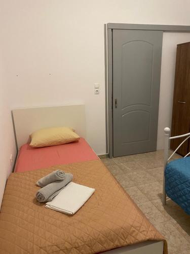 a bedroom with a bed with a towel on it at Sunset Villa Apartments Alepokhori in Káto Alepokhórion