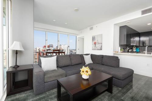 a living room with a couch and a table at Stunning 3BR High Rise Pool, Spa & Rooftop Views in Los Angeles