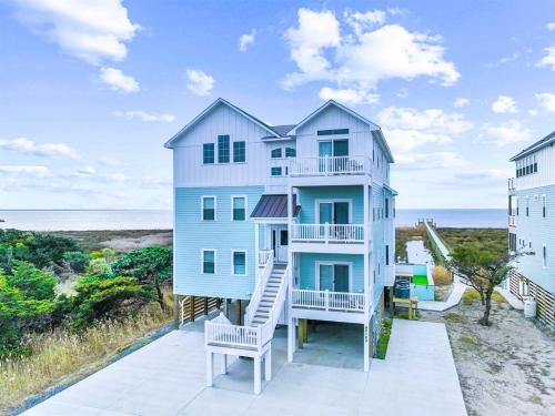 a house on the beach with a slide at 8478 - Seas the Breeze II in Avon