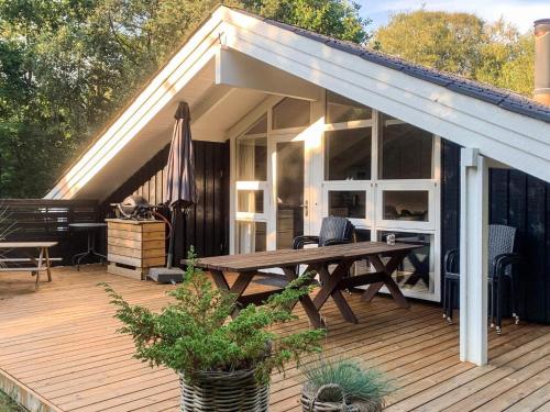 a patio with a wooden deck with a picnic table at 6 person holiday home in Hals-By Traum in Hals
