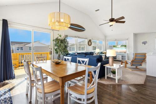 a dining room and living room with a table and chairs at 6001 - Beach Daze in Nags Head