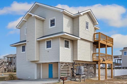 una casa con un balcón encima en 6001 - Beach Daze, en Nags Head
