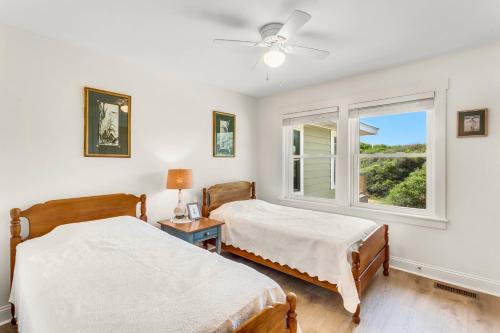 two beds in a room with a window at 3018 - Celestial Mermaid in Southern Shores