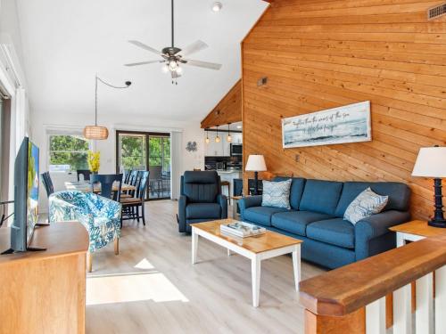 a living room with a blue couch and a table at 3041 - The Beach House in Southern Shores