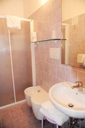 a bathroom with a sink and a toilet and a shower at EuroHotel in Cesenatico