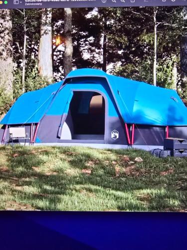 a blue and silver tent sitting in the grass at Camping - Park Władysławowo in Władysławowo
