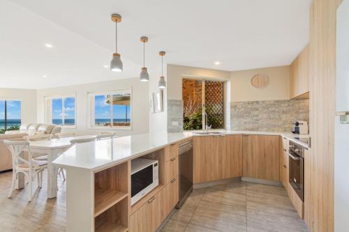 a kitchen with a white counter top and a table at Tahnee Court Unit 3 in Gold Coast