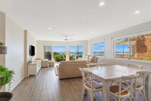 a living room with a table and chairs at Tahnee Court Unit 3 in Gold Coast