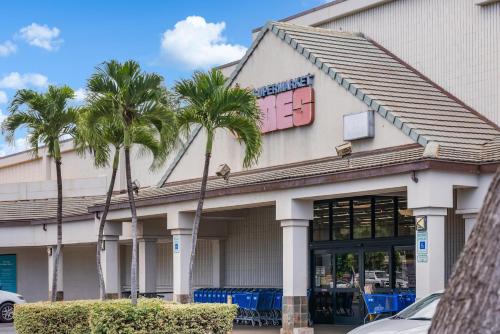 a building with palm trees in front of it at Kaanapali Shores 940 · KS 940 Top Floor Studio w Ocean Views AC in Lahaina