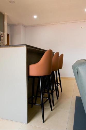 a row of orange chairs sitting at a counter at ICOSIUM House ALGER in Birkhadem