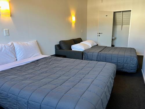 Ένα ή περισσότερα κρεβάτια σε δωμάτιο στο Midwaymotel Rotorua