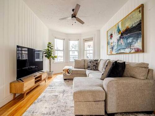 a living room with a couch and a flat screen tv at Urban Oasis 3BR Apt with Iconic WTC View in Jersey City