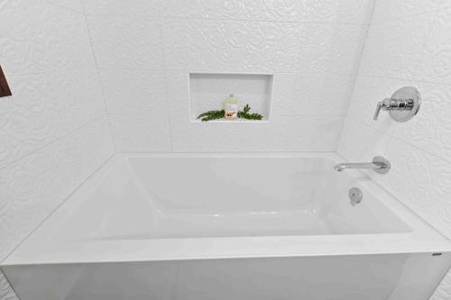 a white bath tub in a bathroom with a sink at Suite Ucluelet in Ucluelet