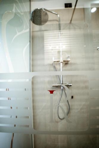 a bathroom with a shower and a red vase at Independent Rooms in Verona