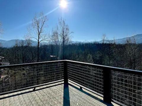 a view of a balcony with the sun in the sky at Seven Bears in the Woods -Modern-Luxury-Cabin--Hot Tub-Game Room in Sevierville