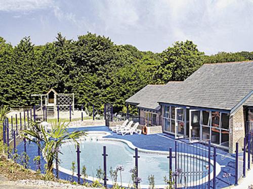 a house with a swimming pool next to a fence at Haven -79 in Perranwell
