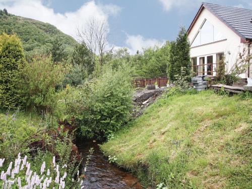 a house on a hill next to a river at Stob-Ban View - S4582 in Fort William