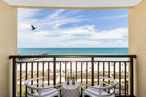 a balcony with a view of the beach at Paradis By Casanita - Oceanfront Lux Designer Suite in Myrtle Beach