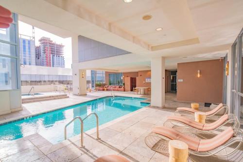 a swimming pool with lounge chairs in a building at Skyline 2BR Pool & Parking W D in Phoenix