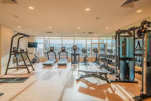 a gym with rows of treadmills and machines at Tranquil 1BR with Parking Gym Pool in Phoenix