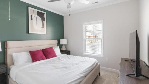 a bedroom with a bed and a flat screen tv at Landing Beautiful 1BD Clubhouse Pool in Owens Cross Roads