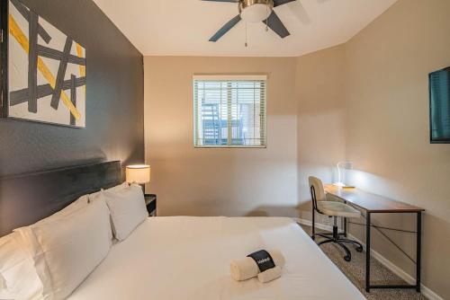 a bedroom with a bed with a ceiling fan and a desk at Gym Pool Near ASU Sloan Pk WasherDryer Parking in Tempe