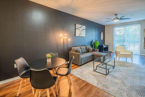 a living room with a table and chairs and a couch at Gym Pool Near ASU Sloan Pk WasherDryer Parking in Tempe