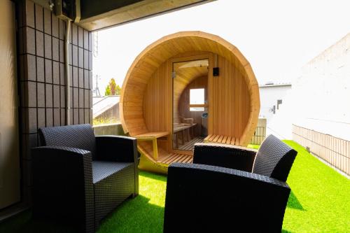 an outdoor area with chairs and a circular building at BRUCE Luxury House in Izumi-Sano