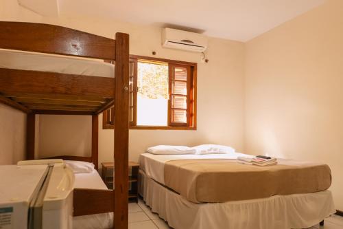 a bedroom with two bunk beds and a window at HANNA Amsterdam Hotel & Eventos in Florianópolis