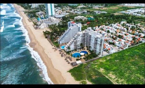 an aerial view of a beach with hotels and the ocean at FRENTE AL MAR A PIE DE PLAYA ALBERCA y JACUZZI 7 in Mazatlán