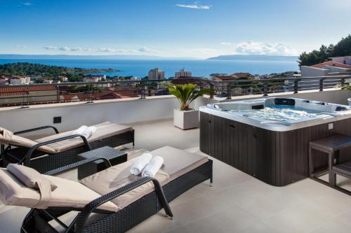 a hot tub on the roof of a house at Villa Palladium in Makarska