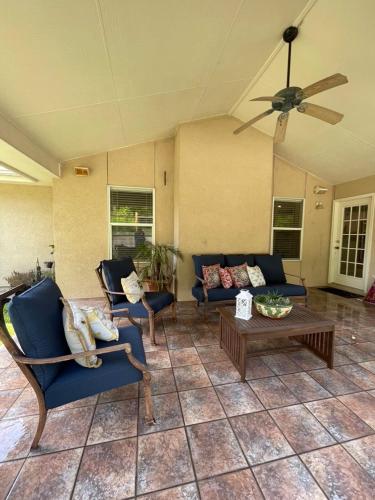 a living room with blue chairs and a table at Casa Escondida in San Antonio