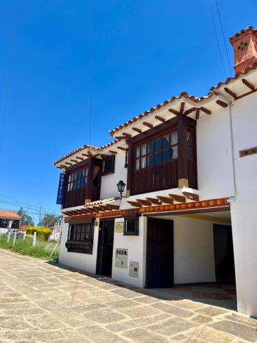 a white building with a brown roof at VILLA LEWANA 2 in Villa de Leyva