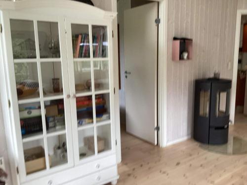 a white cabinet with glass doors in a room at 4 star holiday home in Græsted in Græsted