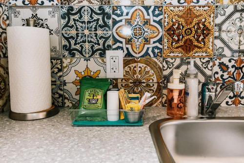 a kitchen counter with a sink and a wall at Adventure Knap Shack in Nordegg