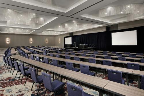 an empty lecture hall with blue chairs and a screen at TownePlace Suites by Marriott Dallas DFW Airport North/Grapevine in Grapevine