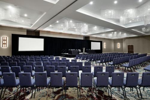 a conference room with blue chairs and a screen at TownePlace Suites by Marriott Dallas DFW Airport North/Grapevine in Grapevine