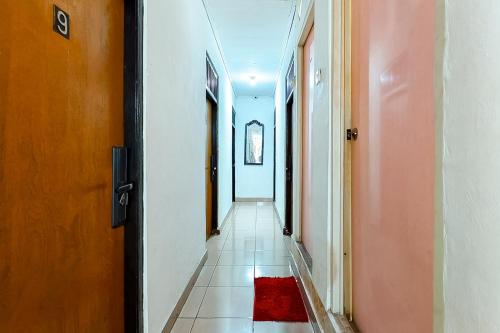 an empty hallway with a red rug on the floor at Danysa Guest House Jakarta RedPartner in Jakarta