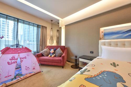 a hotel room with a bedroom with a dinosaur tent at Furama Hotel Dalian in Dalian