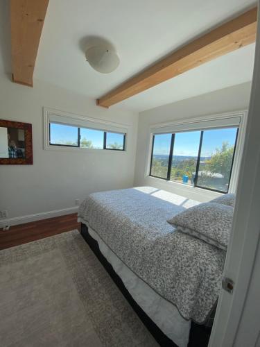 a bedroom with a bed and a large window at Lavandine Farm in Watsonville