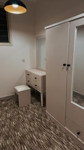 a room with a dresser and a cabinet with a mirror at استديو - smart entry in Abha