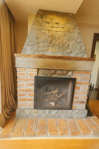 a brick fireplace in a living room at Hotel Medina Del Lago in Otavalo