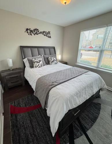a bedroom with a large bed and a window at Charming Spacious 3BR Spring Hill Home! in Spring Hill