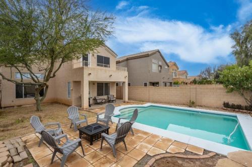a backyard with a pool and chairs and a house at City Escape in Goodyear w Pool Spring Training in Goodyear