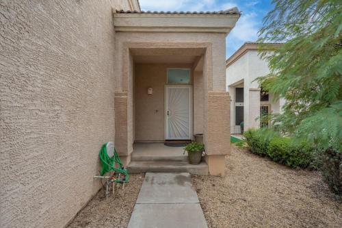 a house with a white door and a bench in front of it at City Escape in Goodyear w Pool Spring Training in Goodyear