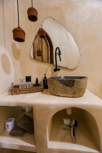 a bathroom with a sink and a mirror at Amani Boutique Stay in Gili Trawangan