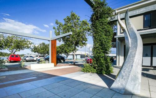 a sculpture in front of a building at Comfy 2-Bedroom Apartment with a Clyde River View in Batemans Bay