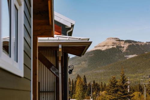 a building with a view of a mountain at Roamer's Nook in Nordegg