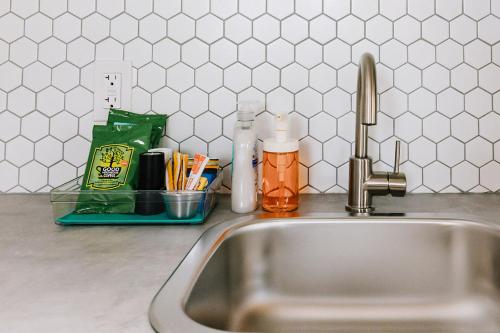 a kitchen sink with a faucet and utensils at Roamer's Nook in Nordegg